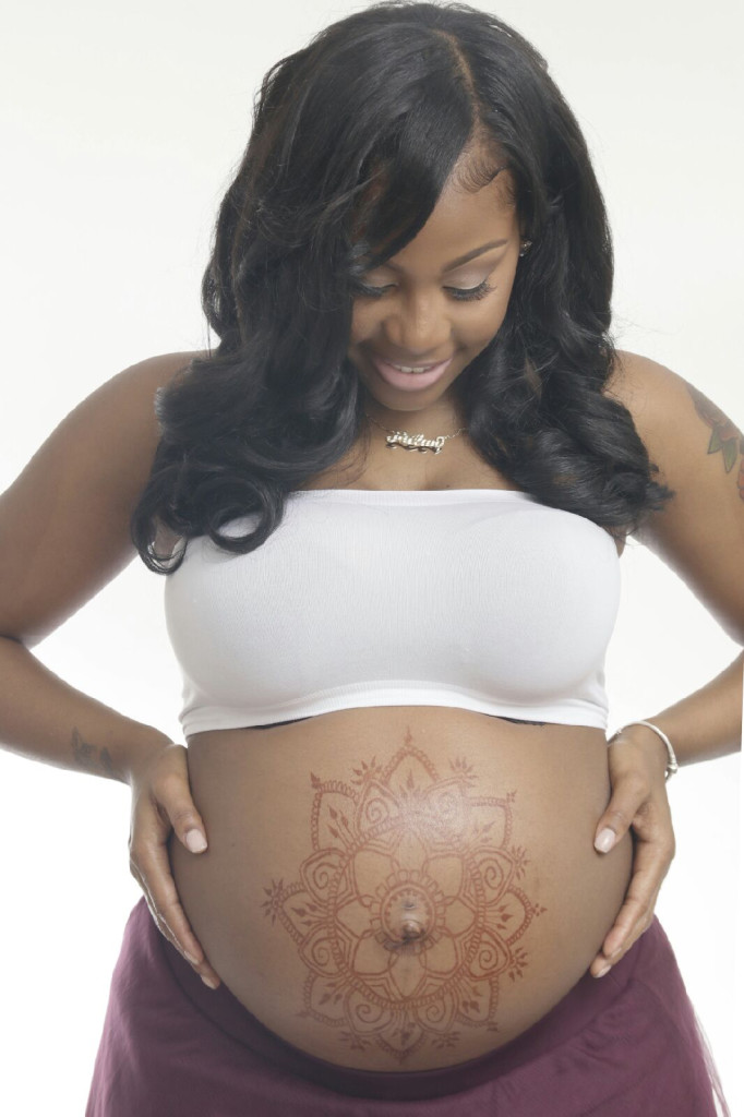 front holding Chardae belly art pregnant pregnant belly painting paint henna hennasooq studio mehndi mehandi