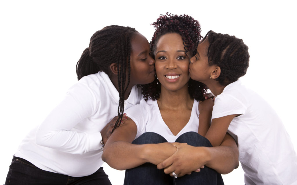 casual young black family on white isolated background